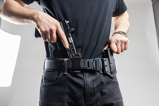 putting gun in holster belt